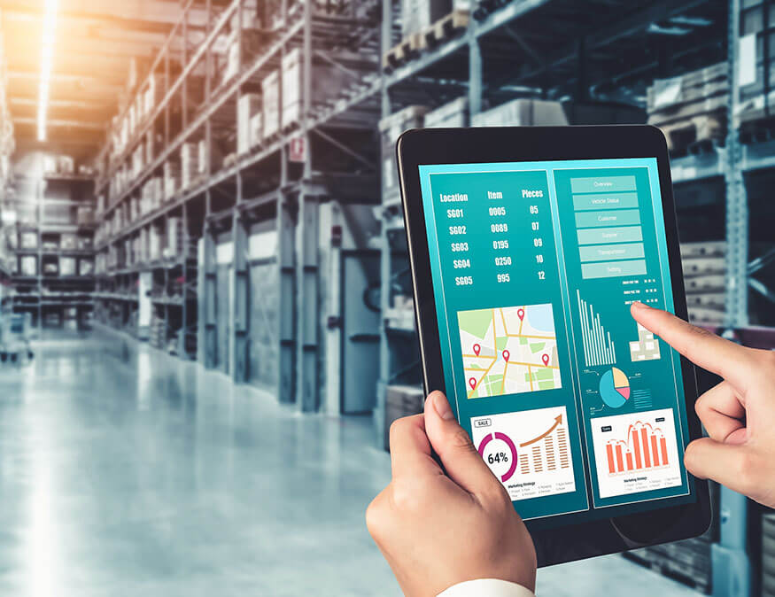 two hands holding a tablet displaying software in a warehouse